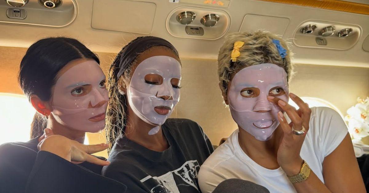 image of Kendall Jenner and her friends try on face masks on their way to the island. 